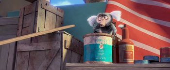 Movie still from “Rio” (2011), directed by Carlos Saldanha – A monkey sitting on top of a barrel; Medium shot, High angle