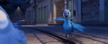 Movie still from “Rio” (2011), directed by Carlos Saldanha – A blue bird is walking down the sidewalk; Wide shot, Low angle