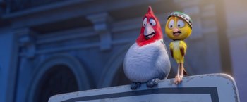 Movie still from “Rio” (2011), directed by Carlos Saldanha – A red and white bird sitting on top of a ledge next to a yellow bird; Medium shot, Low angle