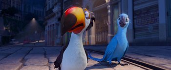 Movie still from “Rio” (2011), directed by Carlos Saldanha – Two birds are sitting next to each other on the sidewalk; Close Up shot, Low angle