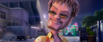 Movie still from “Rio” (2011), directed by Carlos Saldanha – A man with dreadlocks wearing a yellow shirt and sunglasses; Close Up shot, High angle