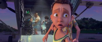Movie still from “Rio” (2011), directed by Carlos Saldanha – A boy is looking into the camera in a room with other people; Close Up shot, Over the shoulder angle