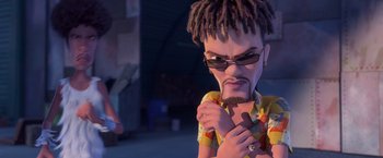Movie still from “Rio” (2011), directed by Carlos Saldanha – A man with dreadlocks holding a piece of wood; Medium shot, Over the shoulder angle