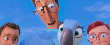 Movie still from “Rio” (2011), directed by Carlos Saldanha – An animated bird and a man with glasses; Close Up shot, Low angle