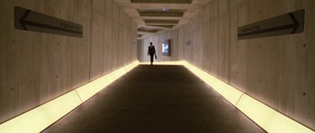 Movie still from “Rise of the Planet of the Apes” (2011), directed by Rupert Wyatt – A man walking down a long hallway in a building; Extreme Wide shot, High angle