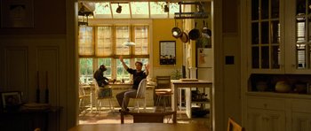 Movie still from “Rise of the Planet of the Apes” (2011), directed by Rupert Wyatt – A man sitting at a table in front of a woman; Wide shot, Low angle