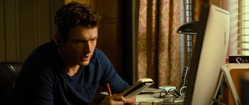 Movie still from “Rise of the Planet of the Apes” (2011), directed by Rupert Wyatt – A young man is writing on a notebook; Close Up shot, Over the shoulder angle