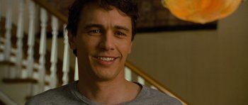 Movie still from “Rise of the Planet of the Apes” (2011), directed by Rupert Wyatt – A person smiling for the camera; Close Up shot, Over the shoulder angle