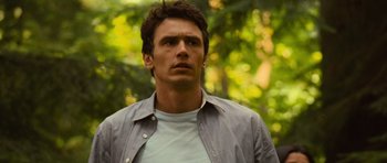 Movie still from “Rise of the Planet of the Apes” (2011), directed by Rupert Wyatt – A person wearing a shirt; Close Up shot, Over the shoulder angle
