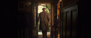 Movie still from “Rise of the Planet of the Apes” (2011), directed by Rupert Wyatt – A man walking through a door way in a house; Wide shot, Low angle