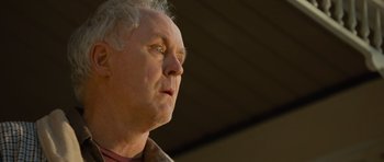 Movie still from “Rise of the Planet of the Apes” (2011), directed by Rupert Wyatt – An older man with white hair is looking up; Close Up shot, Low angle