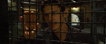 Movie still from “Rise of the Planet of the Apes” (2011), directed by Rupert Wyatt – A man looking through the bars of a jail cell; Close Up shot, Over the shoulder angle