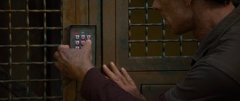 Movie still from “Rise of the Planet of the Apes” (2011), directed by Rupert Wyatt – A man pressing a button on an electronic device; Extreme Close Up shot, Overhead angle