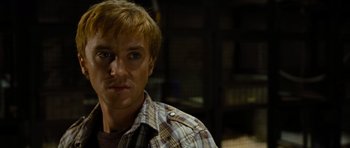 Movie still from “Rise of the Planet of the Apes” (2011), directed by Rupert Wyatt – A person wearing a plaid shirt; Close Up shot, Over the shoulder angle