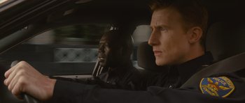 Movie still from “Rise of the Planet of the Apes” (2011), directed by Rupert Wyatt – Two men in the back seat of a car looking out the window; Close Up shot, Over the shoulder angle