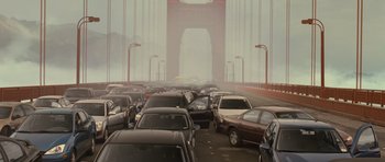 Movie still from “Rise of the Planet of the Apes” (2011), directed by Rupert Wyatt – A bunch of cars that are parked on the side of a bridge; Extreme Wide shot, High angle