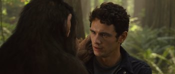 Movie still from “Rise of the Planet of the Apes” (2011), directed by Rupert Wyatt – A monkey is touching a man's face with his hand; Close Up shot, Over the shoulder angle