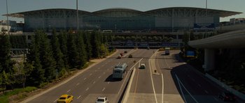 Movie still from “Rise of the Planet of the Apes” (2011), directed by Rupert Wyatt – An aerial view of a freeway with a train station in the background; Extreme Wide shot, High angle