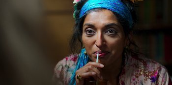 Movie still from “Roald Dahl's Matilda the Musical” (2022), directed by Matthew Warchus – A person holding a straw; Close Up shot, Over the shoulder angle