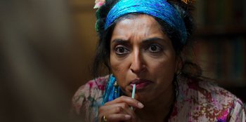 Movie still from “Roald Dahl's Matilda the Musical” (2022), directed by Matthew Warchus – A person holding a toothbrush in her mouth; Close Up shot, Over the shoulder angle