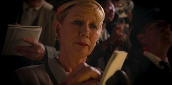 Movie still from “Roald Dahl's Matilda the Musical” (2022), directed by Matthew Warchus – An older woman is holding a piece of paper; Close Up shot, Low angle