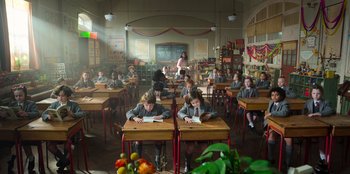 Movie still from “Roald Dahl's Matilda the Musical” (2022), directed by Matthew Warchus – A group of students sitting at their desks in a classroom; Wide shot, High angle