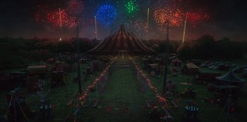 Movie still from “Roald Dahl's Matilda the Musical” (2022), directed by Matthew Warchus – A circus tent with fireworks in the background; Extreme Wide shot, High angle