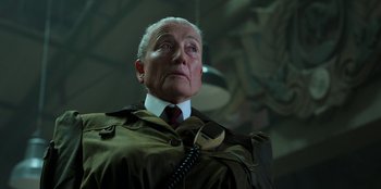 Movie still from “Roald Dahl's Matilda the Musical” (2022), directed by Matthew Warchus – An older man wearing a suit and tie; Close Up shot, Low angle