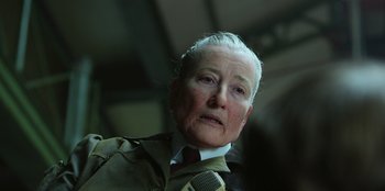 Movie still from “Roald Dahl's Matilda the Musical” (2022), directed by Matthew Warchus – An older man with a white hair and a red tie; Close Up shot, Low angle