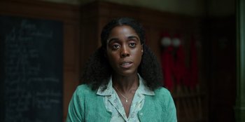 Movie still from “Roald Dahl's Matilda the Musical” (2022), directed by Matthew Warchus – A woman in a green sweater and a white shirt; Close Up shot, Over the shoulder angle