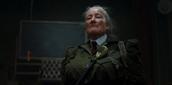 Movie still from “Roald Dahl's Matilda the Musical” (2022), directed by Matthew Warchus – An old man in a military uniform is looking up; Close Up shot, Low angle