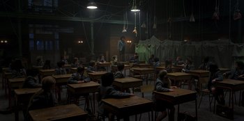 Movie still from “Roald Dahl's Matilda the Musical” (2022), directed by Matthew Warchus – A group of people sitting at desks in a room; Wide shot, High angle