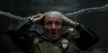 Movie still from “Roald Dahl's Matilda the Musical” (2022), directed by Matthew Warchus – An older woman is holding her head in her hands; Close Up shot, High angle