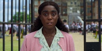 Movie still from “Roald Dahl's Matilda the Musical” (2022), directed by Matthew Warchus – A young woman with brown eyes wearing a pink jacket; Close Up shot, High angle