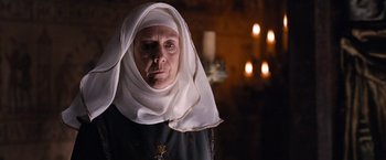 Movie still from “Robin Hood” (2010), directed by Ridley Scott – An old woman wearing a head scarf and a black shirt; Close Up shot, Low angle