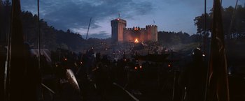 Movie still from “Robin Hood” (2010), directed by Ridley Scott – A crowd of people standing in front of a castle at night; Extreme Wide shot, High angle