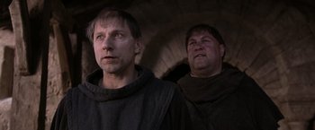 Movie still from “Robin Hood” (2010), directed by Ridley Scott – Two men dressed in medieval garb standing next to each other; Close Up shot, Low angle