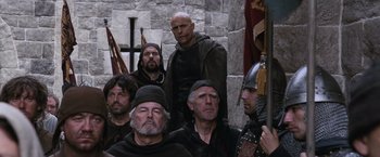 Movie still from “Robin Hood” (2010), directed by Ridley Scott – A group of men in medieval garb posing for a picture; Medium shot, Low angle