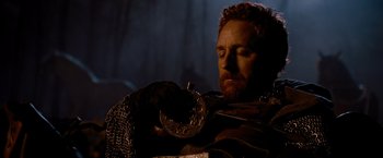 Movie still from “Robin Hood” (2010), directed by Ridley Scott – A person holding a coin; Close Up shot, Over the shoulder angle