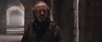 Movie still from “Robin Hood” (2010), directed by Ridley Scott – A person wearing a vest; Close Up shot, Low angle