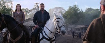 Movie still from “Robin Hood” (2010), directed by Ridley Scott – A man sitting on top of a white horse; Medium shot, Low angle
