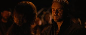 Movie still from “Robin Hood” (2010), directed by Ridley Scott – A man and a woman standing next to each other in the dark; Close Up shot, Over the shoulder angle