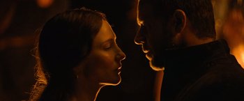 Movie still from “Robin Hood” (2010), directed by Ridley Scott – A man and a woman face to face in the dark; Close Up shot, Over the shoulder angle