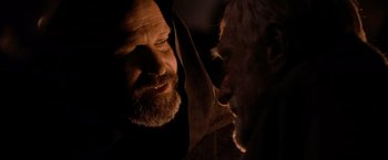 Movie still from “Robin Hood” (2010), directed by Ridley Scott – A man with a long beard looking at another man with a long beard; Close Up shot, Over the shoulder angle