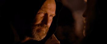 Movie still from “Robin Hood” (2010), directed by Ridley Scott – A man with a beard wearing a hooded sweatshirt; Close Up shot, Over the shoulder angle