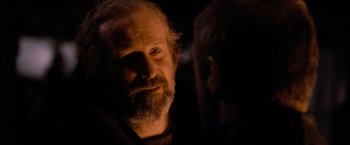 Movie still from “Robin Hood” (2010), directed by Ridley Scott – An older man with a beard and a mustache; Close Up shot, Over the shoulder angle