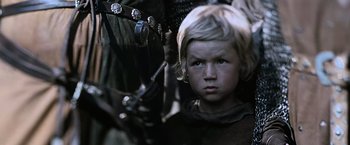 Movie still from “Robin Hood” (2010), directed by Ridley Scott – A young boy is looking into the camera; Close Up shot, Low angle