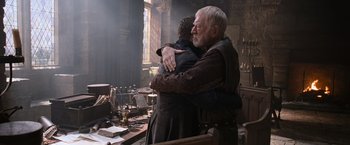 Movie still from “Robin Hood” (2010), directed by Ridley Scott – A man and a woman hugging in a room; Medium shot, Low angle
