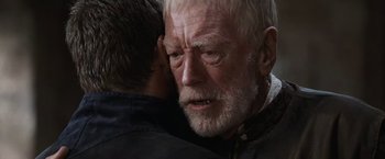 Movie still from “Robin Hood” (2010), directed by Ridley Scott – An older man is hugging a younger man; Close Up shot, Over the shoulder angle