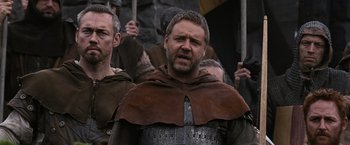 Movie still from “Robin Hood” (2010), directed by Ridley Scott – A group of men standing next to each other; Medium shot, Low angle